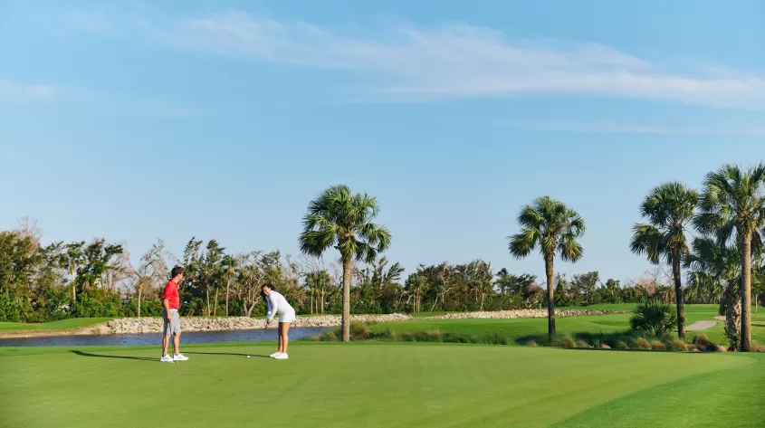Couple playing golf at Bowman's Beach