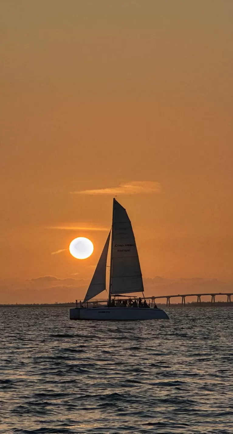 A boat cruises at sunset in Fort Myers Beach.