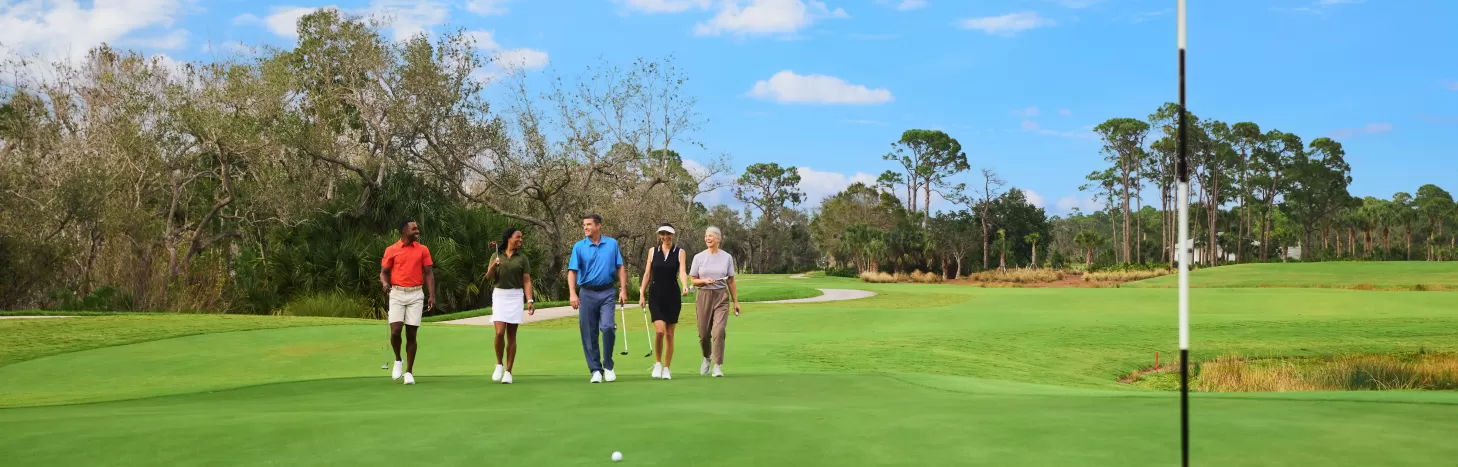 A group walks down the green on a Golf course