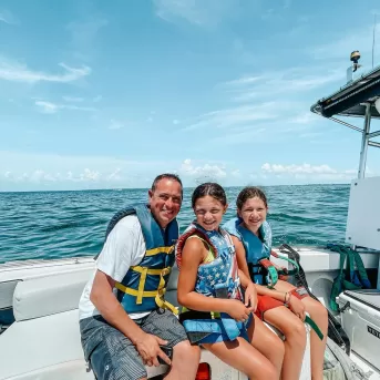 A boat cruises on the water in Fort Myers Beach.